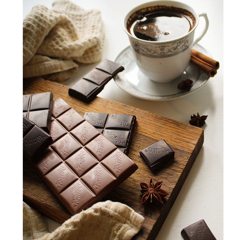 A cup of drinking chocolate and chocolate bars