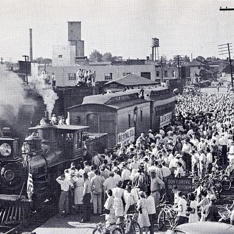 Train at a station with people around